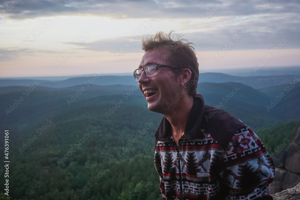 Smiling guy on Krasnoyarsk pillars at sunset