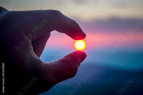 The sun in the hand of a man