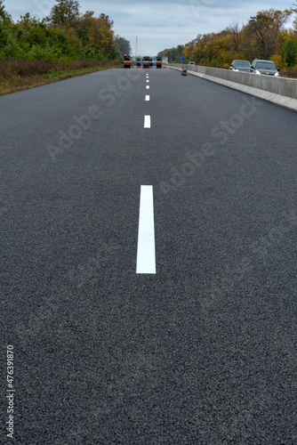 Road marking on the new asphalt on new road. Road construction. © Andrii