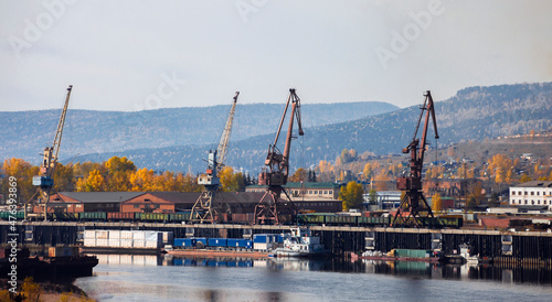 Loading of the northern delivery by cranes from wagons to barges for transportation along the Lena River to Yakutia.