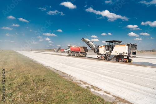Milling machine removes the top layer of concrete on the runway for repairs