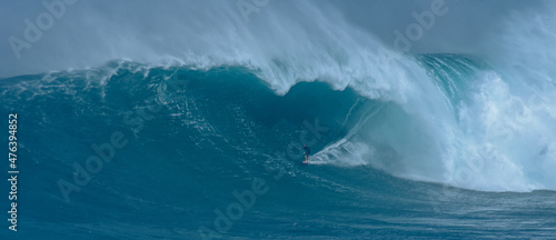 Sport photography. Jaws swell on International surfing event in Maui, Hawai 2021 December.