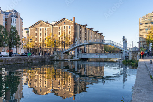 Paris, France - 10 24 2021: Reflections on the Ourcq canal of the lift bridge at sunrise