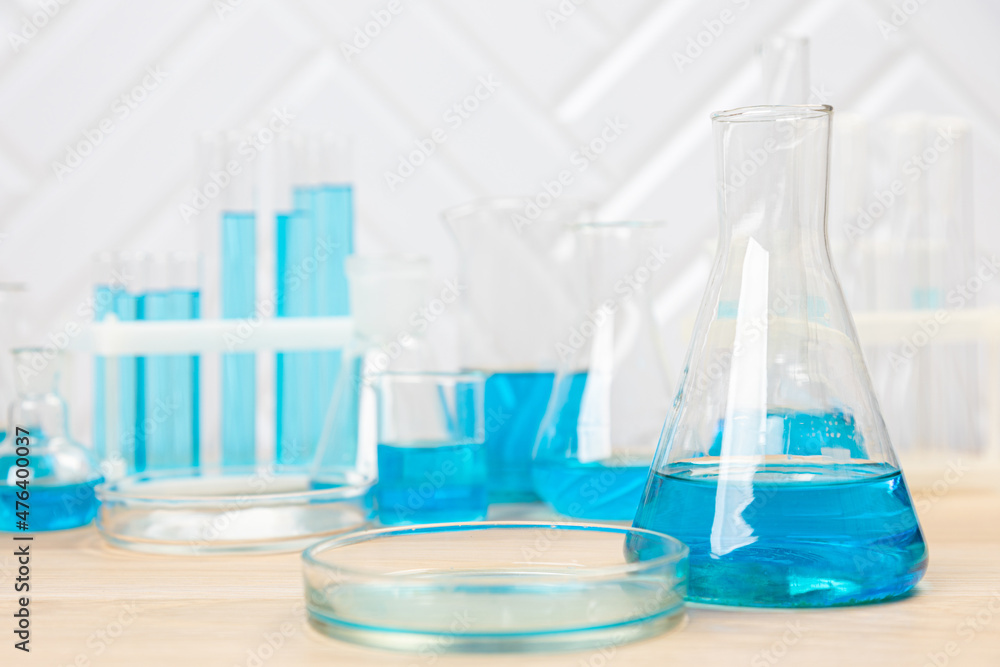 Laboratory glassware with blue liquid in a test tube. scientific laboratory flasks, droppers, Petri dishes, beakers and cylinders, laboratory equipment