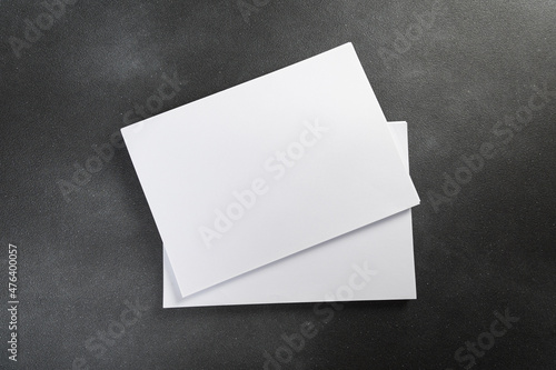 White business card sheet of paper a4 stack on a dark table. Clean portrait A4. © Nana_studio