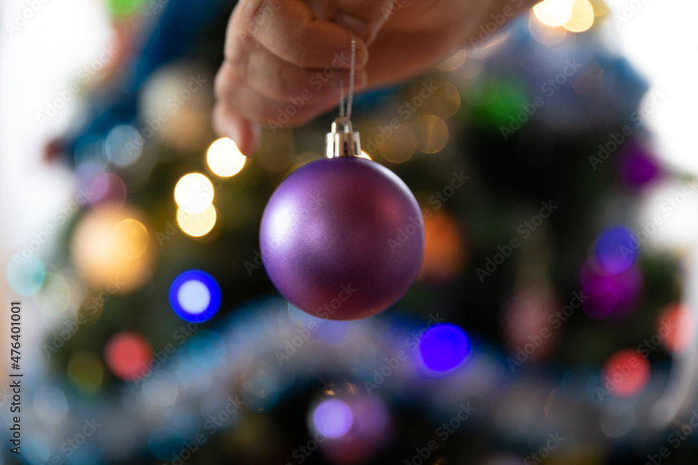 Fototapeta premium Soon Christmas and New Year, decorating the tree with toys