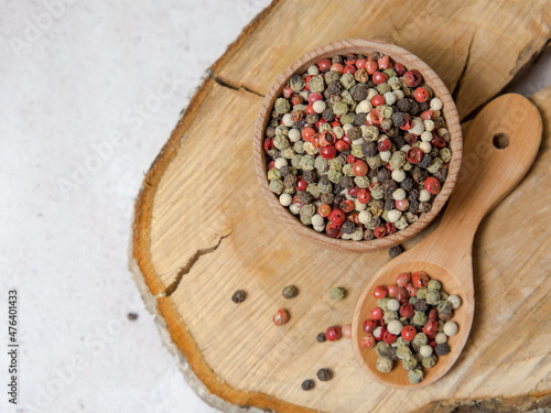 Pepper mix. Black  red  green  white peppercorns spices  Mix of different peppers in a wooden spoon