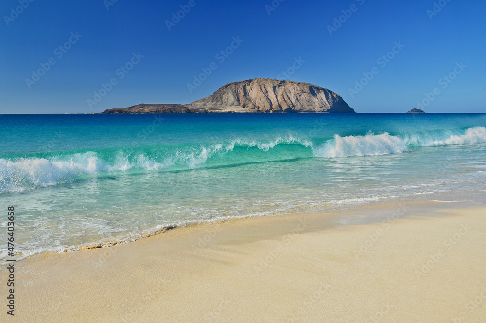 Beautiful Playa de las Conchas with Montana Clara in the background. The island La Graciosa, belonging to Lanzarote, Canary Islands, Spain.