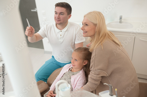 A male doctor showing the xray results to the kids mom photo