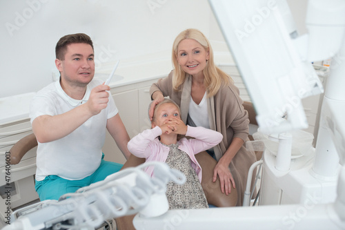 A male doctor showing the xray results to the kids mom photo