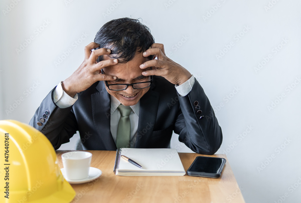 Business man serious when disappointed and sad, tired from his project or work Business man serious when disappointed and sad, tired from his project or work