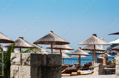 beach hut with umbrellas near Old Town Budva in Montenegro  Europe  Adriatic Sea and mountains 