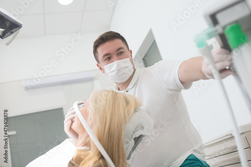 Doctor in a sterile gloves switching on medical equipment photo