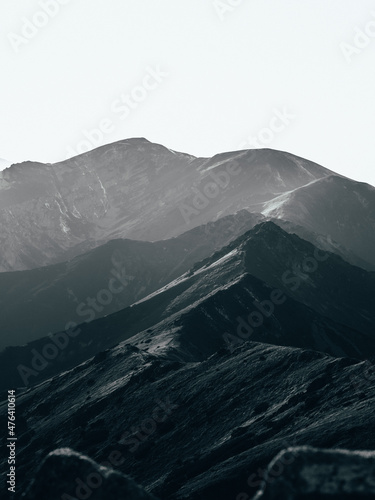 Desaturated mountain range landscape with clear sky