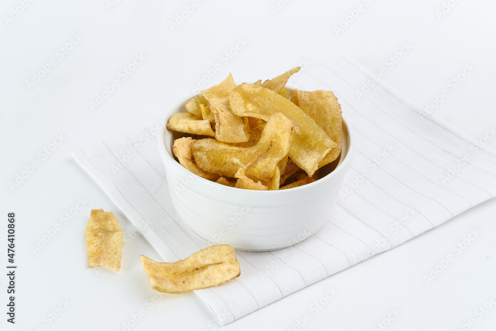 Heap of dried banana chips snack on white background. Selective focus image, blurred background.
Heap of dried banana chips snack on white background. Selective focus image, blurred background.