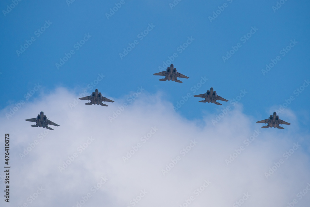 Five fighter aircrafts in v-formation with blue sky and white clouds. Five fighter aircrafts in v-formation with blue sky and white clouds.