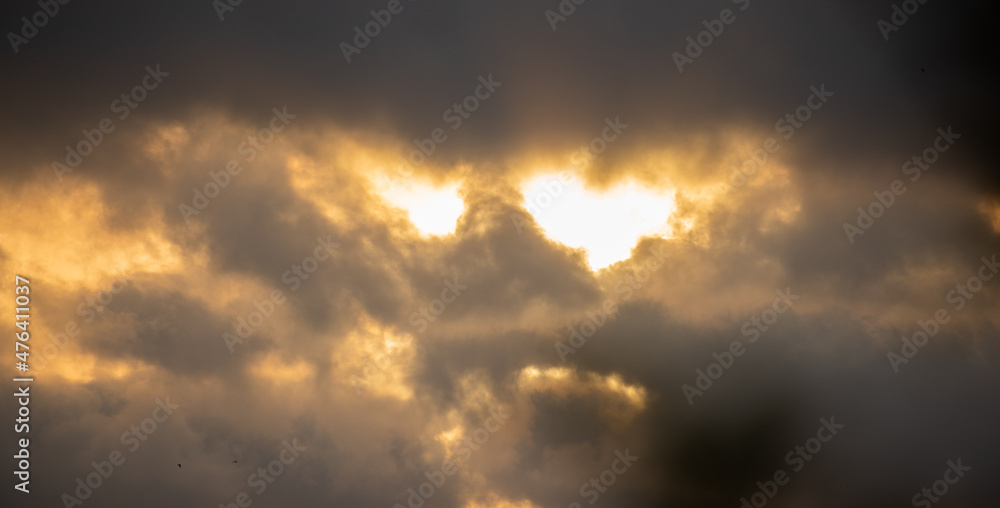 Sun is shining through stormy clouds and it looks like a face. Sun is shining through stormy clouds and it looks like a face.