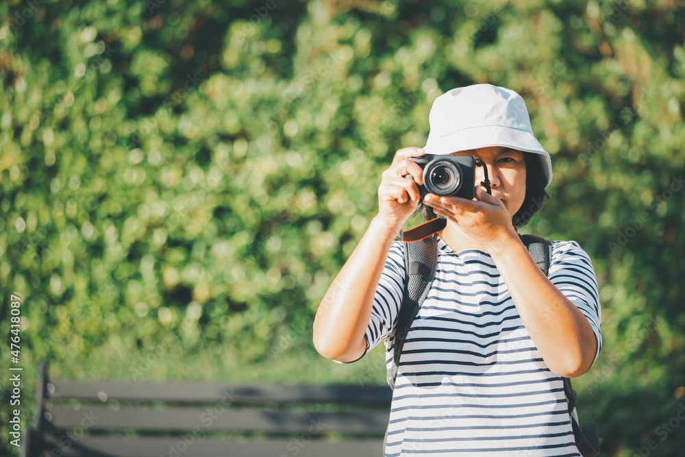 Asian woman tourists taking pictures with digital camera, Asian female photographer with holding professional digital camera vintage picture style, Travel concept. Asian woman tourists taking pictures with digital camera, Asian female photographer with holding professional digital camera vintage picture style, Travel concept.