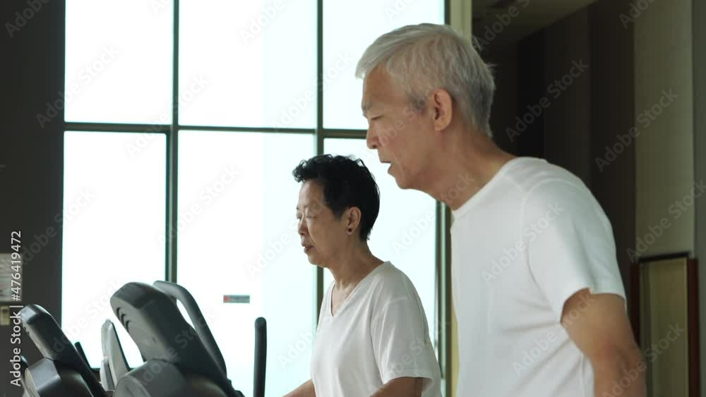 Asian senior couple exercise walking threadmill together urban returement healthy lifestyle Asian senior couple exercise walking threadmill together urban returement healthy lifestyle