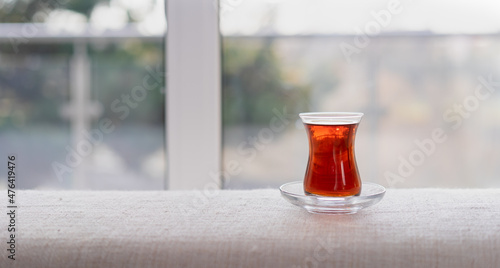 Fotografie, Obraz A glass of black tea in front of the window, traditional Turkish brewed hot drin