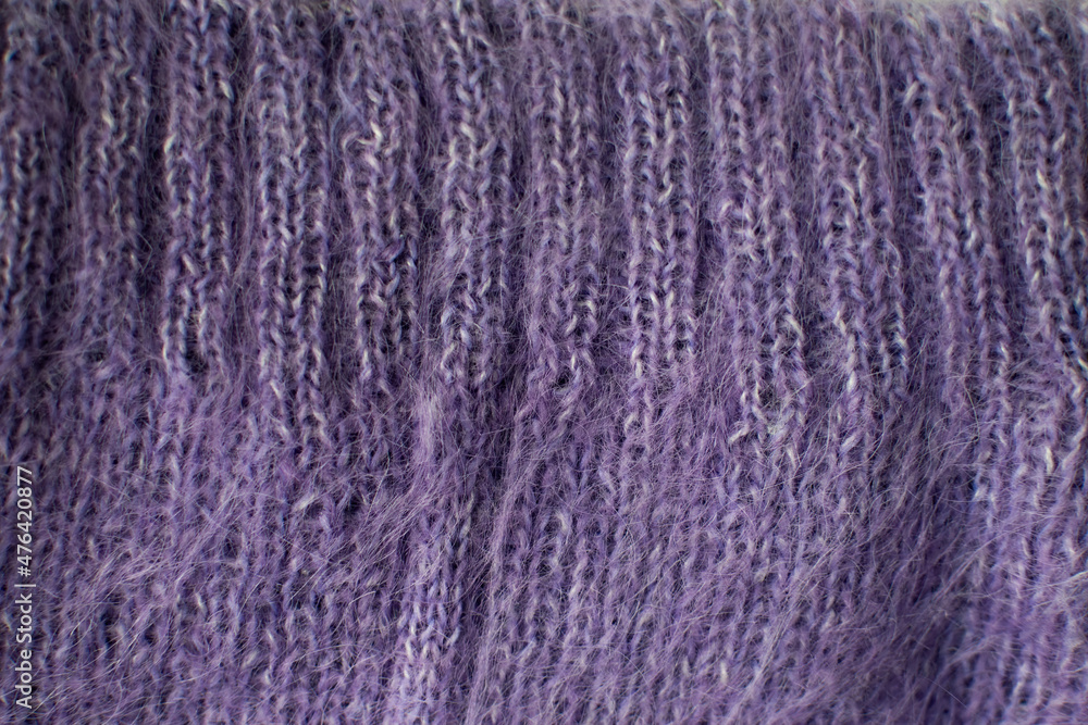 Fototapeta premium Knitted violet woolen sweater. Violet texture with cable pattern. Color 2022.