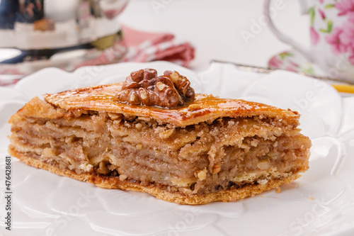 traditional oriental sweetness - baklava with walnuts on a white plate