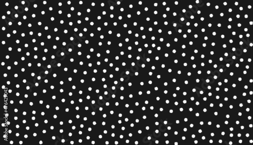 Abstract background with small white distorted polka dots that look like paint blobs on black background. Simple, abstract background. Copy space.