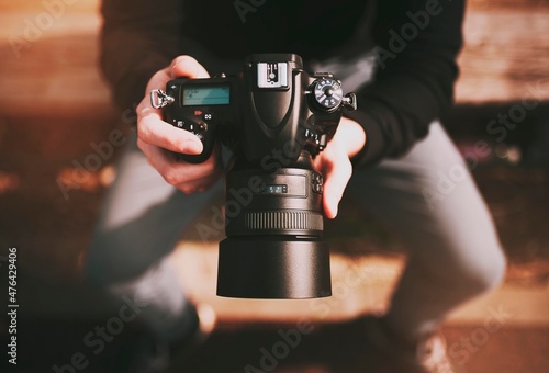 photographer with dslr camera and prime lens. top view.