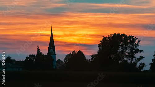 Beautiful sunset view with the silhouette of a church near Strasskirchen, Bavaria, Germany
