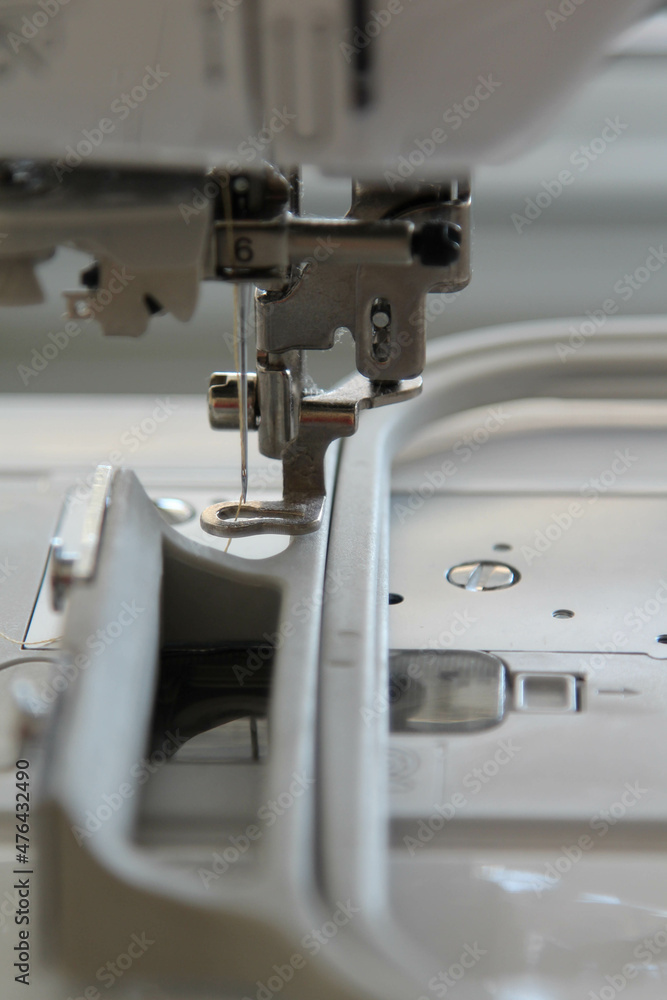 Closeup view of needle and foot of sewing machine. Closeup view of needle and foot of sewing machine.