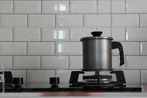 A stainless steel pot on modern gas stove.