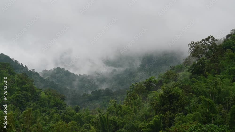Fog captured moving fast in a time lapse over the mountains in Sai Yok, Kanchanaburi, Thailand, during a rainy afternoon. Fog captured moving fast in a time lapse over the mountains in Sai Yok, Kanchanaburi, Thailand, during a rainy afternoon.