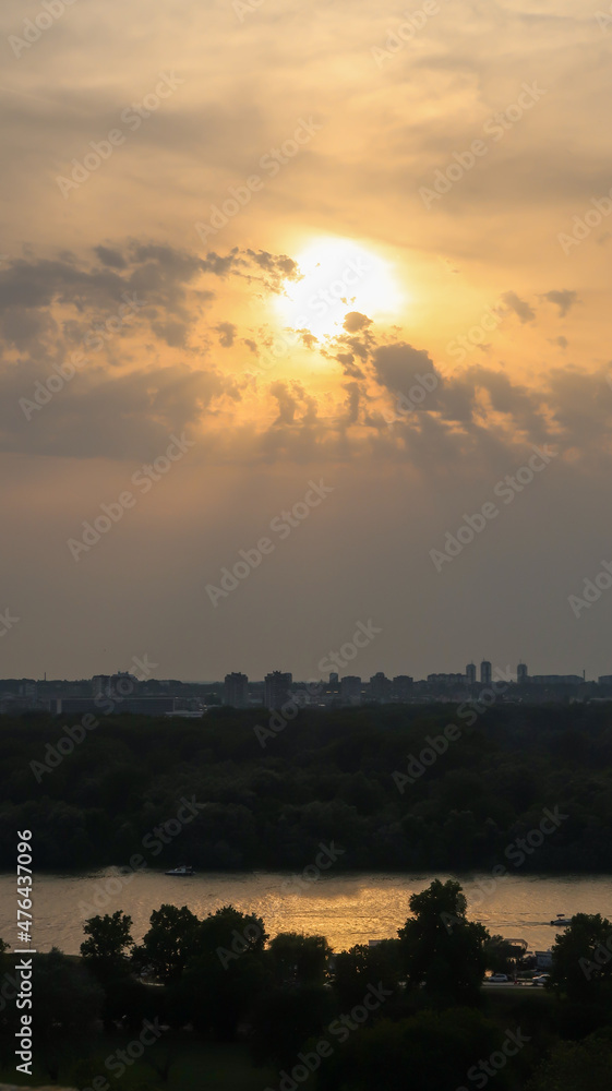 View of beautiful sunset over Zemun, Big War Island and confluense of rivers Danube and Sava, viewed from Kalemegdan fortress in Belgrade, Serbia View of beautiful sunset over Zemun, Big War Island and confluense of rivers Danube and Sava, viewed from Kalemegdan fortress in Belgrade, Serbia
