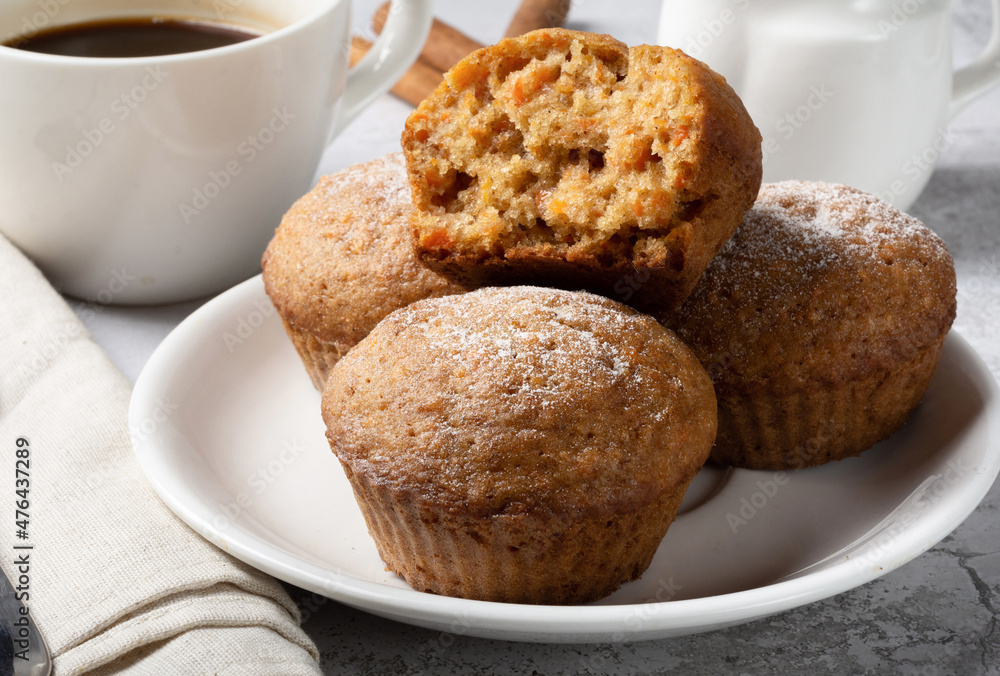 Carrot sweet muffins. Carrot cupcakes with sugar and cinnamon on a light background Carrot sweet muffins. Carrot cupcakes with sugar and cinnamon on a light background