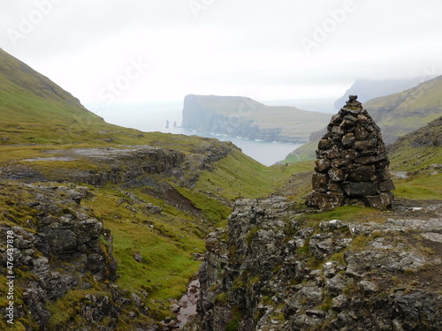 Exploring the green and lush Atlantic Coastline of the Faroe Islands in the Nordics © ChrisOvergaard