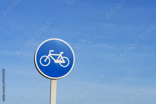 Blue round sign only for bicycles against sky and copy space