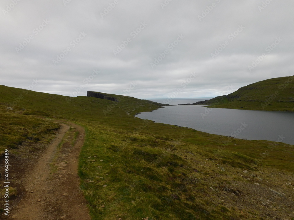 The beautiful Atlantic coastline and islets on the Faroe Islands The beautiful Atlantic coastline and islets on the Faroe Islands