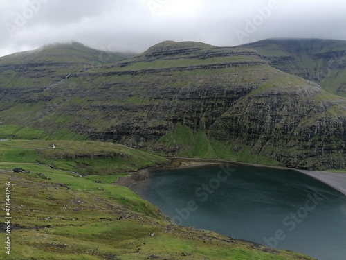 Dramatic cliffs  mountains and coastline on the lush Faroe Islands in the Atlantic Ocean