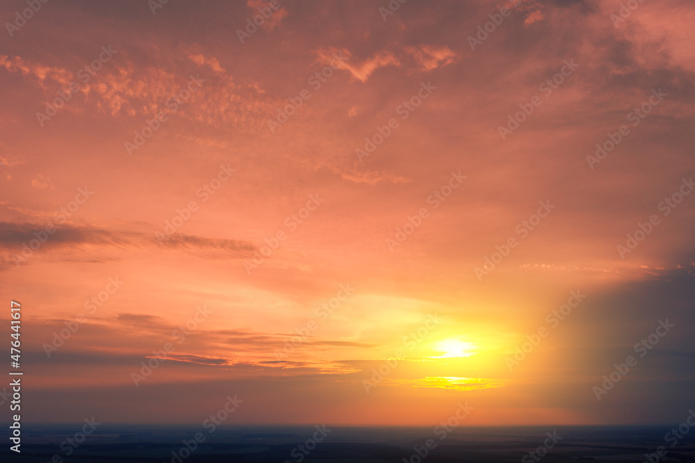 Colorful cloudy sky over the sea at sunset. Sky texture. Abstract nature background
