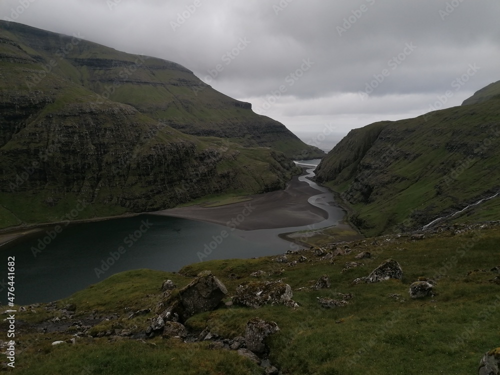 Dramatic cliffs, mountains and coastline on the lush Faroe Islands in the Atlantic Ocean