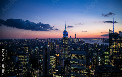 New York City. Manhattan downtown skyline with illuminated Empire State Building and skyscrapers at dusk. High quality photo © VKari