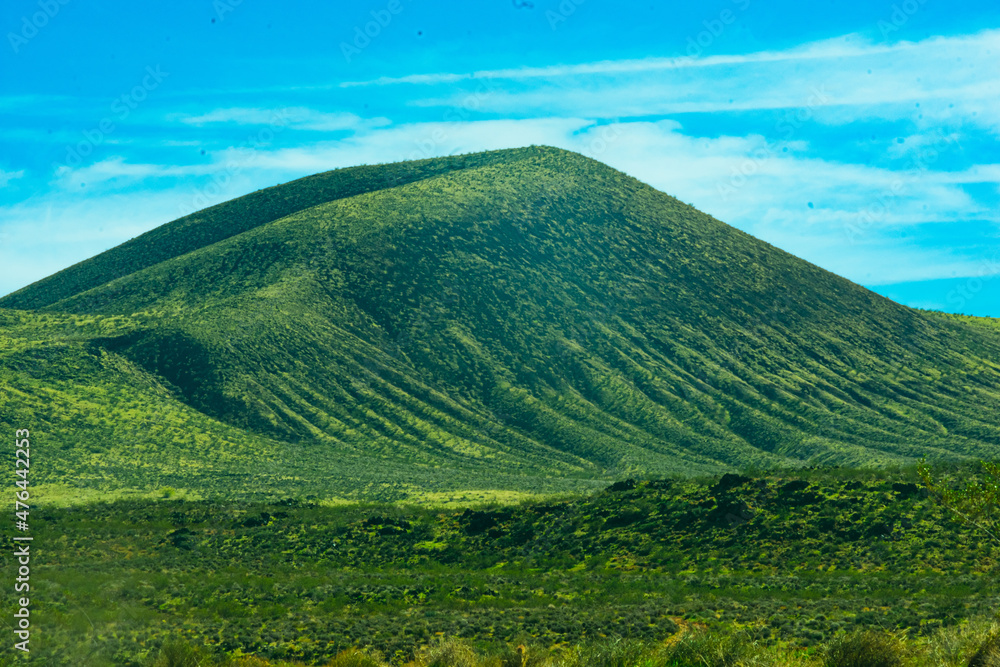 Fototapeta premium Green desert hills against a blue sky