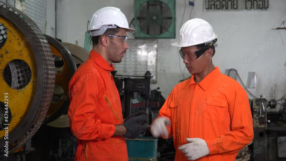 two factory worker handshake after checking quality control of the manufactured part .group of diverse engineer team after shaking hands inspection production in factory two factory worker handshake after checking quality control of the manufactured part .group of diverse engineer team after shaking hands inspection production in factory