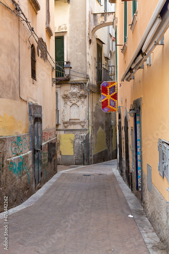 Narrow colorful streets with house altars, laundry in Salerno, Italy