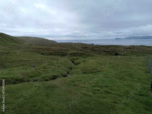 Dramatic cliffs, mountains and coastline on the lush Faroe Islands in the Atlantic Ocean