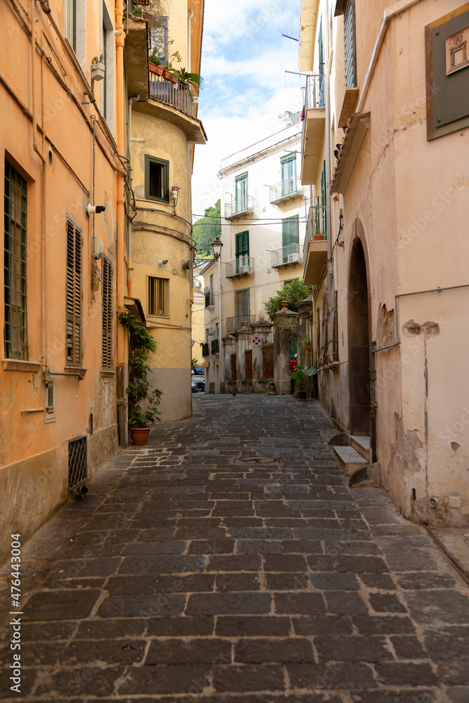 Narrow colorful streets with house altars, laundry in Salerno, Italy