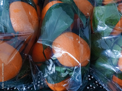 fresh oranges in plastic packaging.
