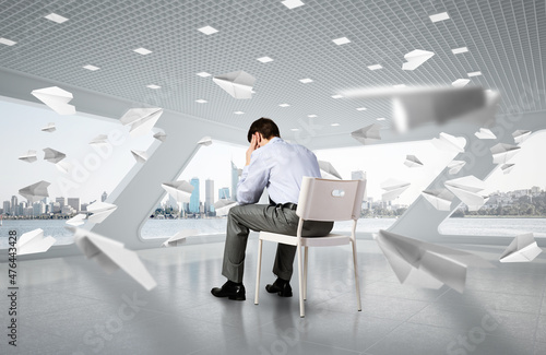 young businessman on chair in office