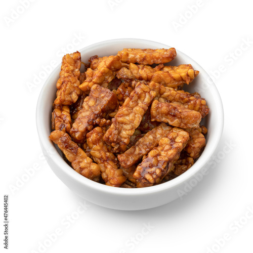 Bowl with homemade Indonesian sambal tempeh goreng close up isolated on white background © Picture Partners