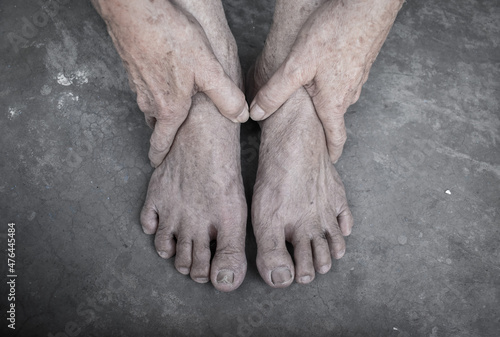 Asian elder man’s hands and feet. Concept of joint health and care, and aging skin.